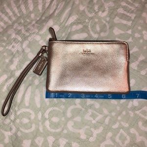 Light pink metallic COACH wristlet